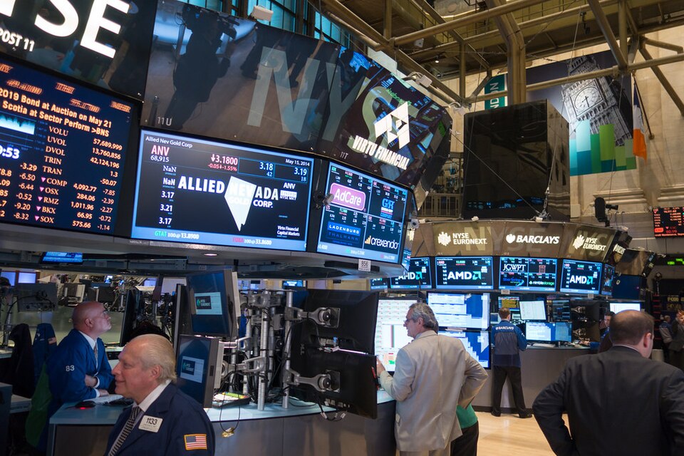 Trading floor at the New York Stock Exchange with traders and monitors