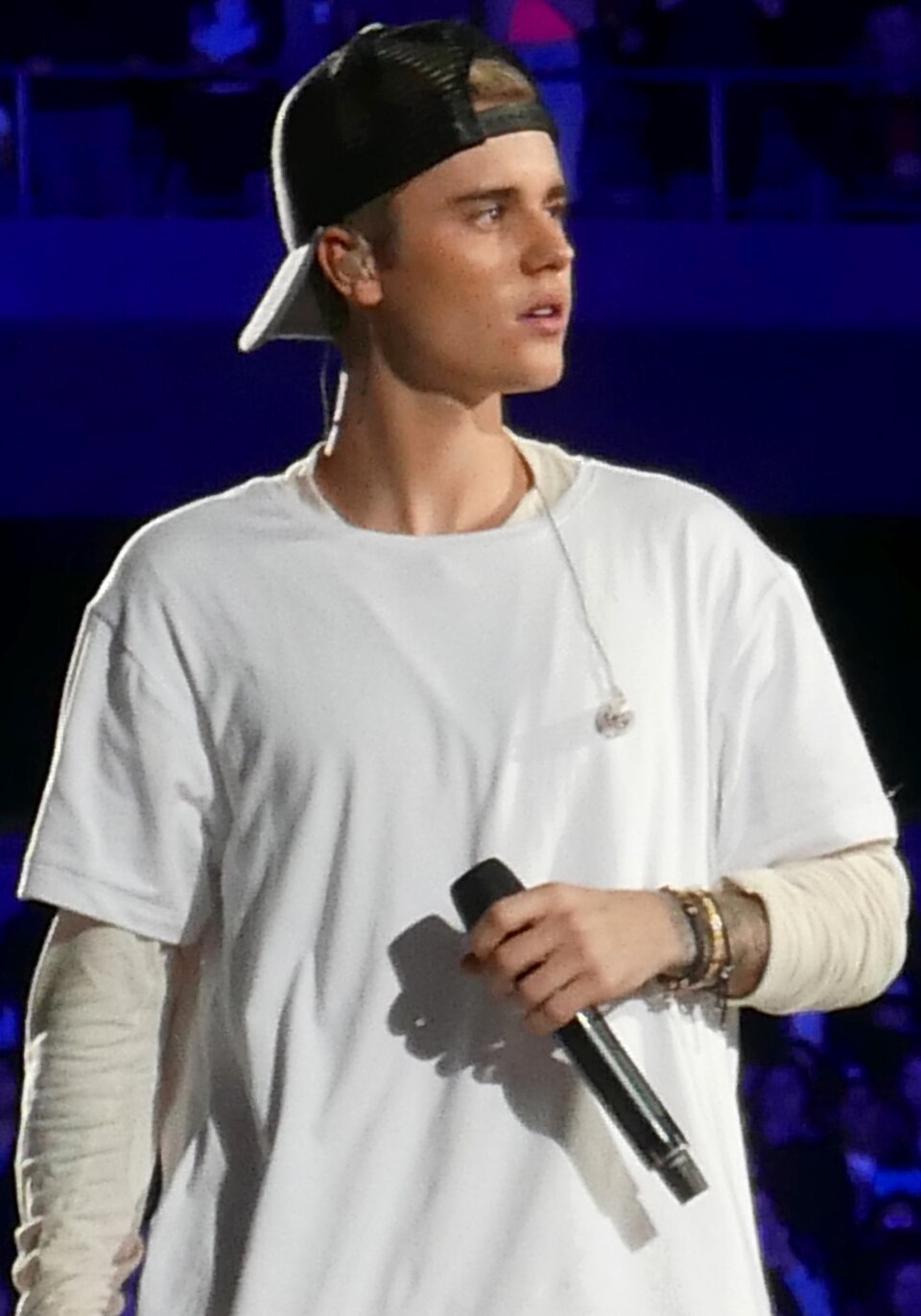 Justin Bieber performing at concert with microphone