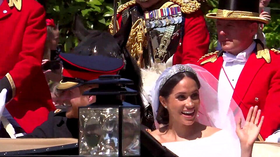 Prince Harry and Meghan Markle in their carriage procession through the streets of Windsor after their 2018 royal wedding