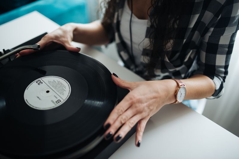 Vinyl record playing on a turntable in a cozy home setting