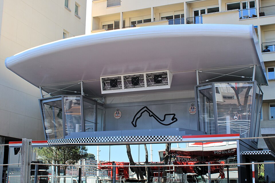 Formula 1 cars racing through the Monaco Grand Prix circuit with harbor views
